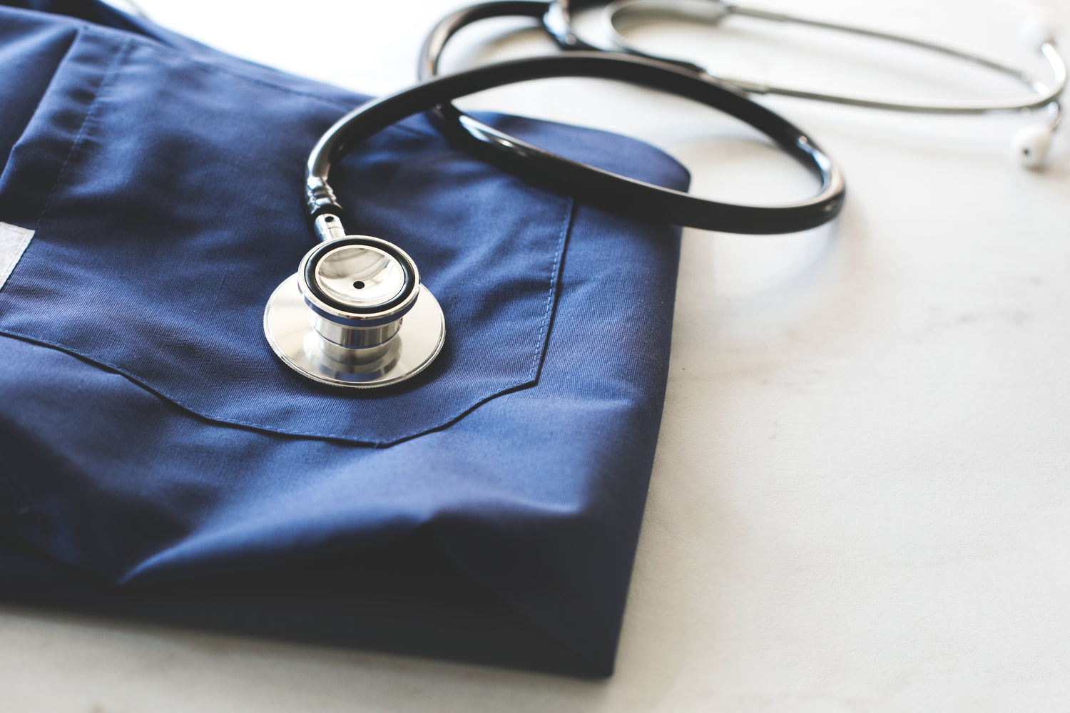 Stethoscope lying on scrubs - the diagnosis